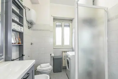 a white bathroom with a toilet and a sink at Il rifugio dei nonni by Rentbeat in Rome