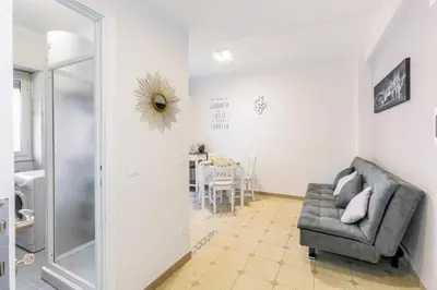 a living room with a chair and a table at Il rifugio dei nonni by Rentbeat in Rome