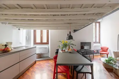a kitchen and living room with a table and chairs at iFlat The Tiber Gem in Rome