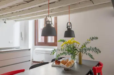 a kitchen with two black lights hanging over a table at iFlat The Tiber Gem in Rome