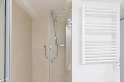 a bathroom with a shower with a glass door at iFlat The Tiber Gem in Rome