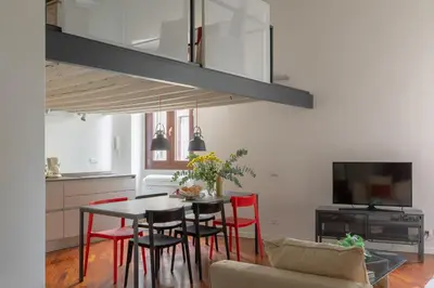 a kitchen and dining room with a table and chairs at iFlat The Tiber Gem in Rome