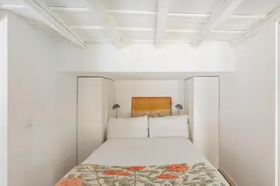a white bedroom with a bed in a white room at iFlat The Tiber Gem in Rome