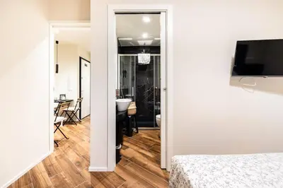 a bedroom with a bed and a dining room with a table at alloggio la carica dei 101 in Rome