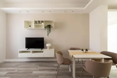 a living room with a tv and a table and chairs at Sweet Rhome to Colosseum in Rome