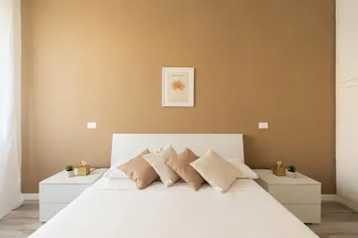 a bedroom with a large white bed with pillows at Sweet Rhome to Colosseum in Rome