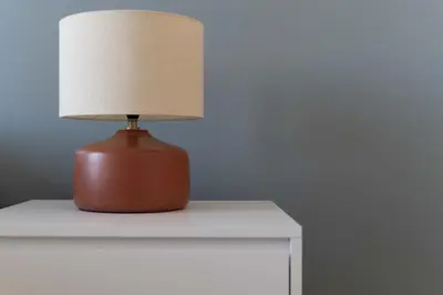 a brown lamp sitting on a white table at Cioccis Boutique Apartment in Rome