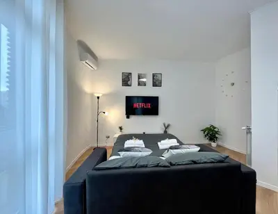 a bedroom with a bed with a clock on the wall at PyramidHouse Rome - Apartment 100mq with View - 2km from the Colosseum in Rome