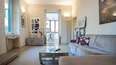 a living room with a couch and a coffee table at EasyTopStay - Trastevere Cozy Nest with Terrace in Rome