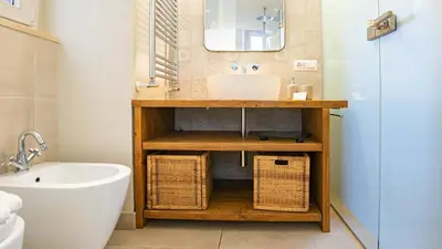 a bathroom with a sink and a mirror and a tub at EasyTopStay - Trastevere Cozy Nest with Terrace in Rome
