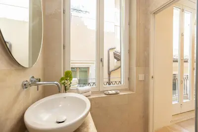 a bathroom with a sink and a window at Amazing Cozy Piazza Venezia in Rome