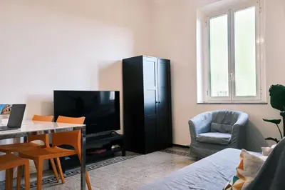 a living room with a television and a black cabinet at Carolina Trastevere House in Rome