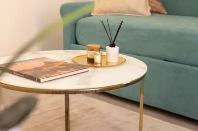 a coffee table with a book and candles on it next to a couch at Élite Vatican Refuge in Rome