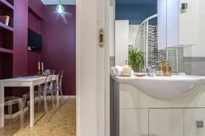 a bathroom with a sink and a dining table at YCH-Cozy Flat at the Vatican in Rome