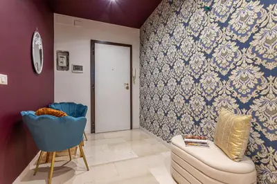 a living room with a couch and a blue wall at YCH-Cozy Flat at the Vatican in Rome