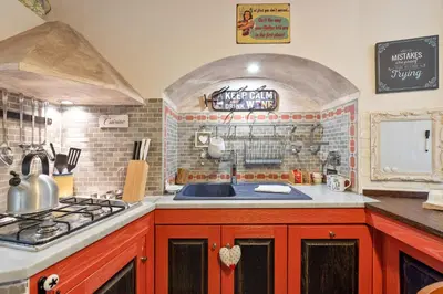 a kitchen with a sink and a stove top oven at Rome as you feel - Casa Governo Vecchio in Rome