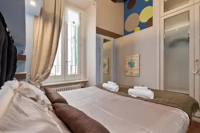 a bedroom with a large bed with towels on it at Rome as you feel - Casa Governo Vecchio in Rome