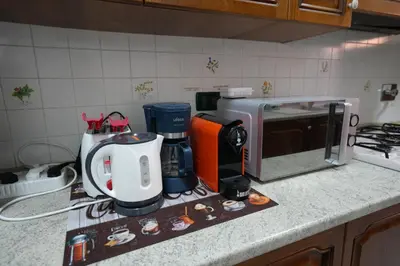 a kitchen counter with a coffee maker and a microwave at House Appio Latino Roma in Rome