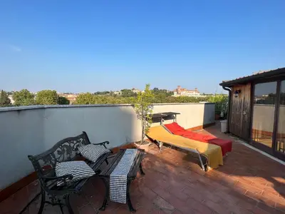 a balcony with a bed and a table and chairs at Chalet dei Girasoli in Rome