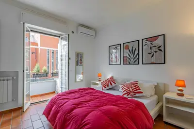 a bedroom with a bed with a red blanket at Milvio Bridge - Olympic Stadium, Farnesina, A-C in Rome