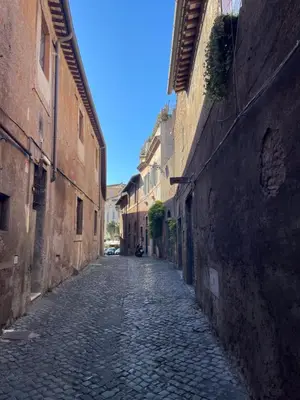 an empty street in an alley between two buildings at STUDIO4 ROMA in Rome