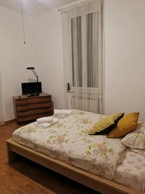 a bedroom with a bed with a dresser and a window at La Casetta di Benedetta in Rome