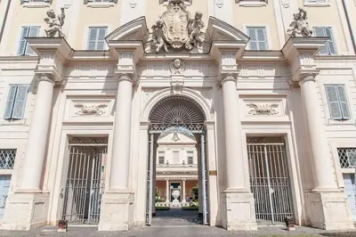 a large white building with an entrance with columns at L'antico borgo di Trastevere III in Rome