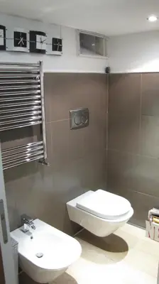 a bathroom with a toilet and a sink at HT Loft Testaccio in Rome