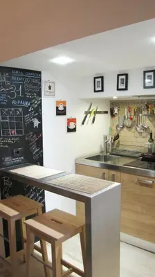 a kitchen with a counter and a chalkboard on the wall at HT Loft Testaccio in Rome