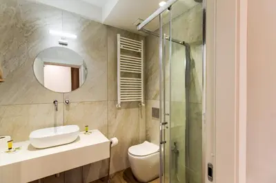 a bathroom with a toilet and a sink and a shower at Navona Secret Stay Guest House in Rome