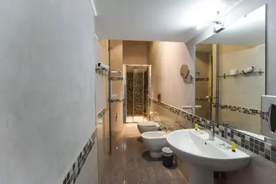 a bathroom with two sinks and two toilets at Navona Secret Stay Guest House in Rome