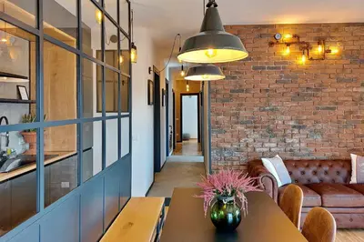 a room with a table and a brick wall at YCH-Trilocale stile Industriale in Rome