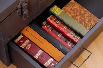 a box full of books sitting on the floor at YCH-Trilocale stile Industriale in Rome