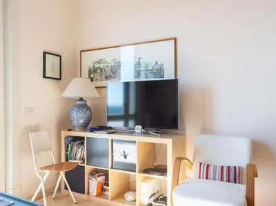 a living room with a tv and a chair at Bright Panorama Apartment in Rome