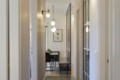 a hallway with a table and a dining room at YCH TRILOCALE FINEMENTE ARREDATO VICINO ALLA METRO in Rome