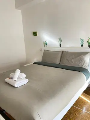 a white bed with towels on it in a room at La Piccoletta di Garbatella in Rome