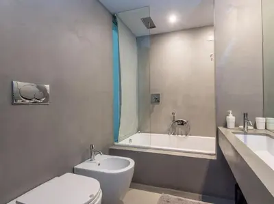 a bathroom with a toilet and a tub and a sink at Luxury Fori Imperiali Flat in Rome