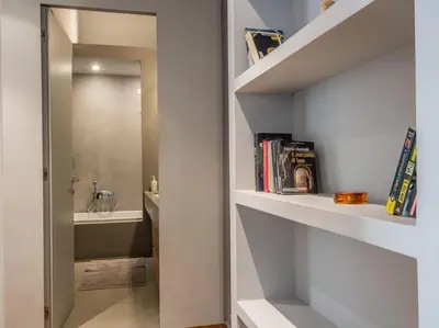 a bathroom with a walk in shower and a sink at Luxury Fori Imperiali Flat in Rome