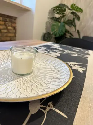 a glass of milk on a plate on a table at Arya Roma Vaticano in Rome