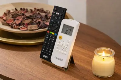 a remote control sitting on a table next to a candle at Arya Roma Vaticano in Rome