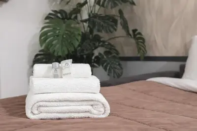 a stack of towels sitting on top of a bed at Arya Roma Vaticano in Rome