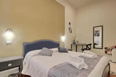 a bedroom with a bed with towels on it at Dreaming Rome Suites in Rome