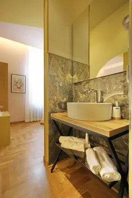 a bathroom with a sink on a counter with towels at Dreaming Rome Suites in Rome