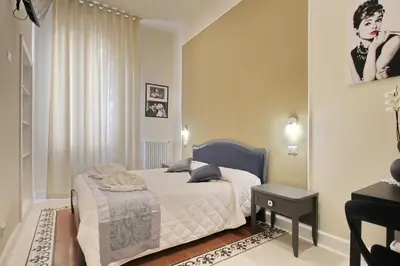 a bedroom with a bed and a table in it at Dreaming Rome Suites in Rome