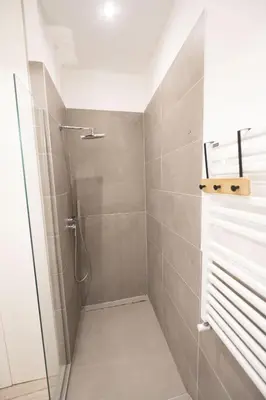 a bathroom with a shower with a glass door at Vintage and Design in the Heart of Vibrant Pigneto in Rome