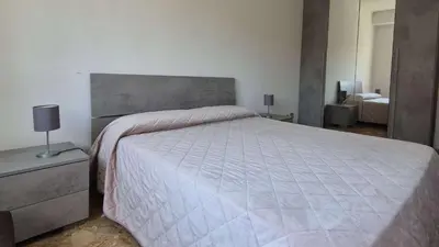 a bedroom with a large bed with a large headboard at Camera matrimoniale vicino a San Pietro in Rome