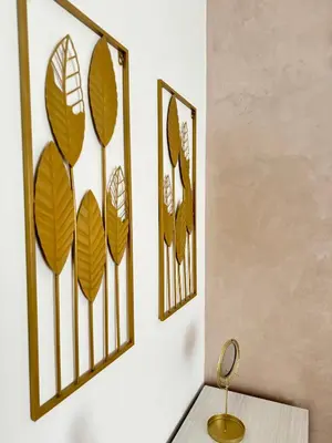 a room with three framed leaves on the wall at Maddalena Means Home in Rome