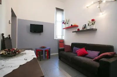 a living room with a couch and a table at Alloggio Turistico Cadorna - Fontana di Trevi , Via Veneto Piazza di Spagna in Rome