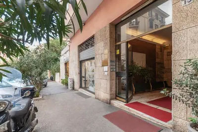 a building with a car parked outside of it at GuestHost - MM Re di Roma Apartment in Rome
