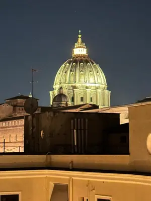 a domed building in the background of a city at Apartment Roma Centro San Pietro e Musei Vaticani in Rome